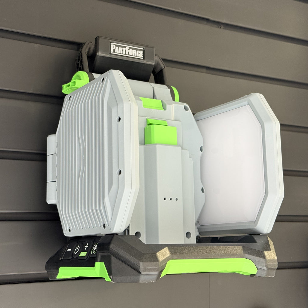 EGO LT1000 area light hanging by its handle on a PartForge slatwall mount