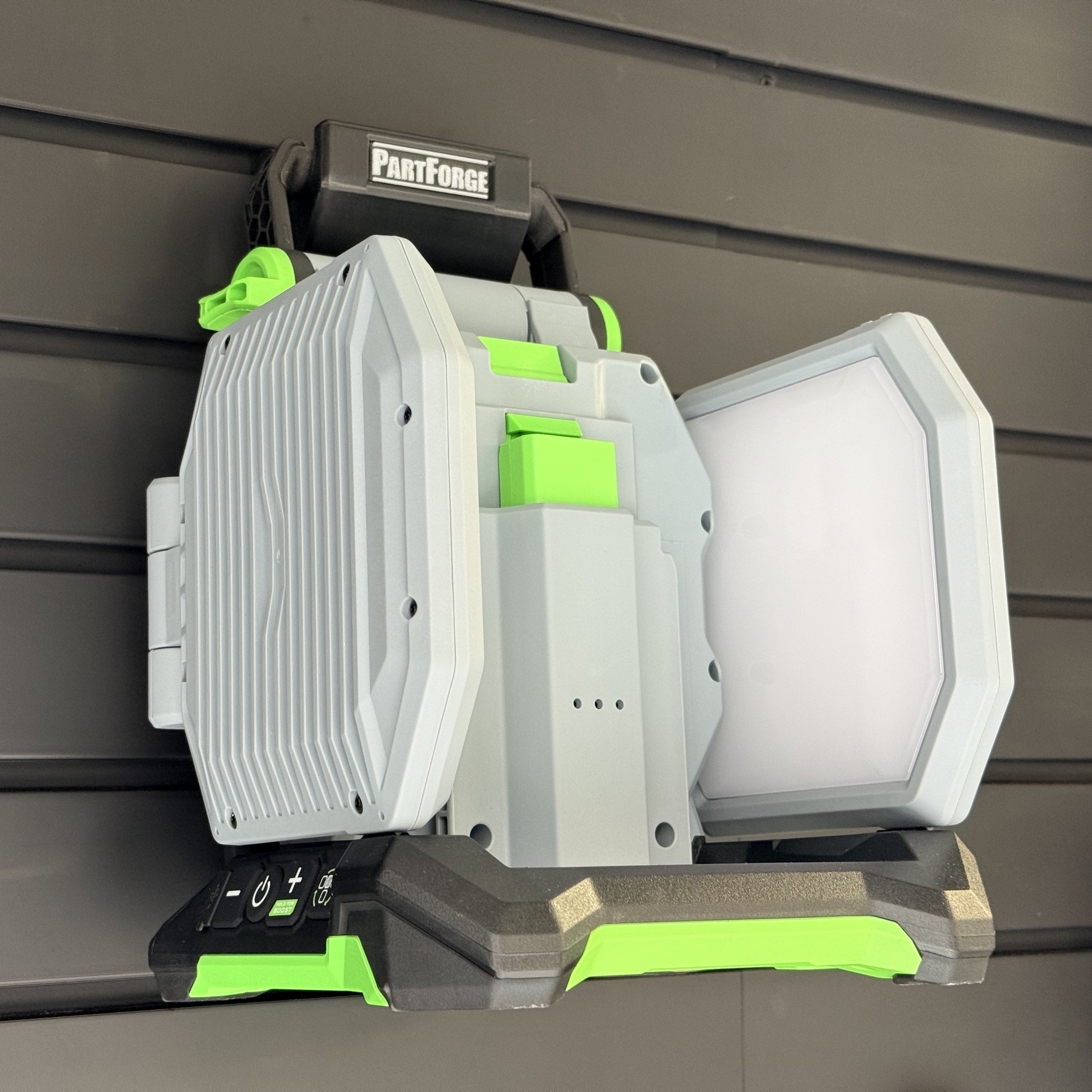 EGO LT1000 area light hanging by its handle on a PartForge slatwall mount