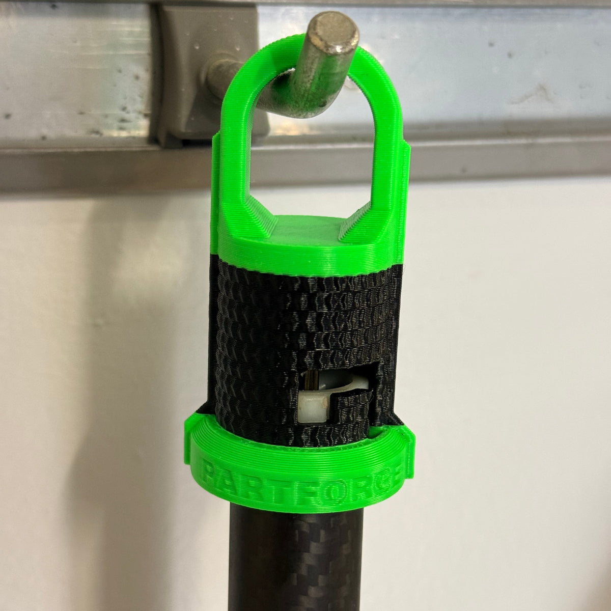 EGO Multi-Head attachment hook holding an attachment shaft