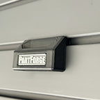 PartForge mounting bracket for EGO mower bags installed on a Gladiator GearWall panel.