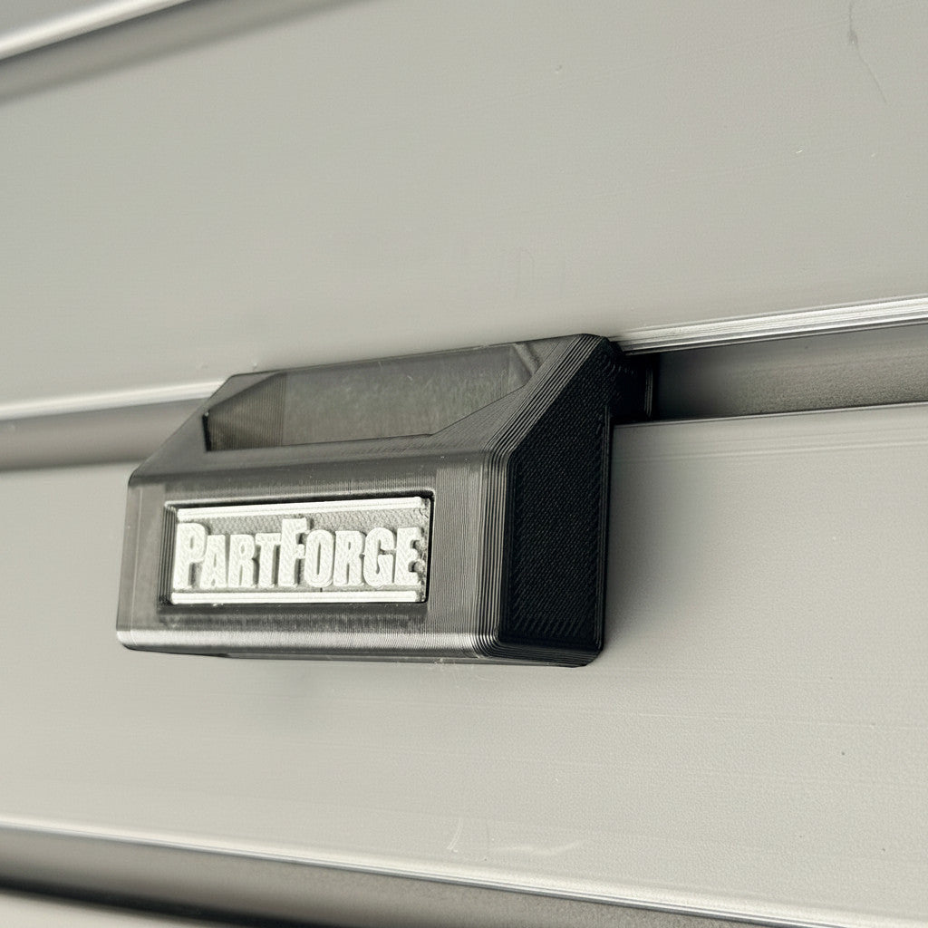 PartForge mounting bracket for EGO mower bags installed on a Gladiator GearWall panel.